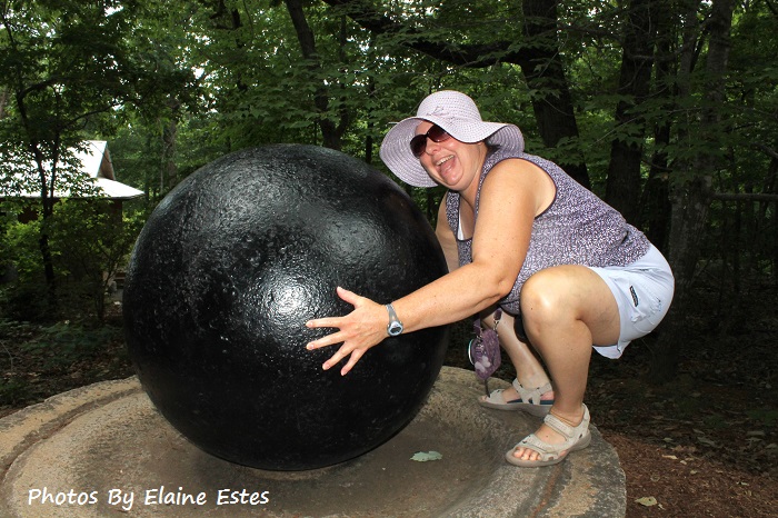 Friend pretending to lift huge ball.