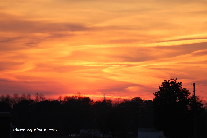 The sunset like golden and orange waves on a purple sea..