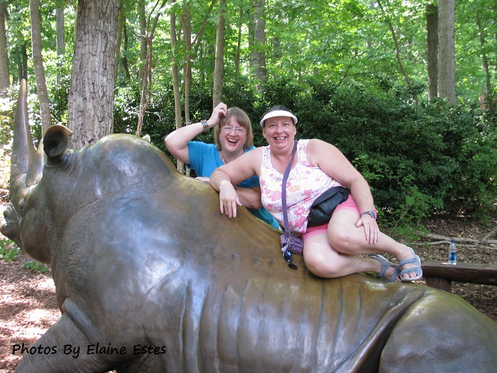 Friends on the back of a rhino statue.