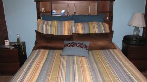 My bed with headboard and shelves.
